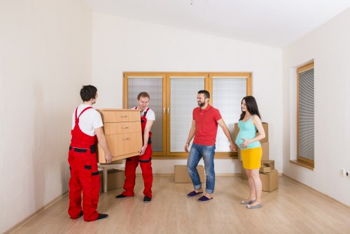 Professional movers loading furniture into a moving truck