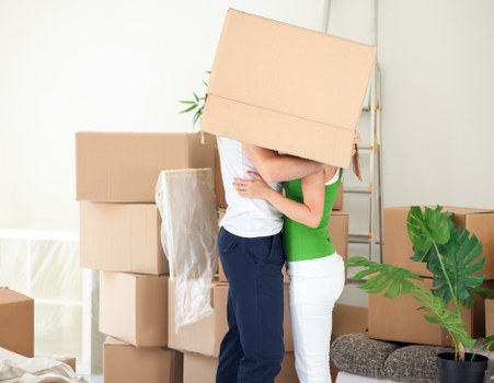 Furniture and boxes being loaded into a removal van in west London