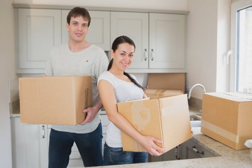 Packed office equipment and furniture ready for transport during a local business move